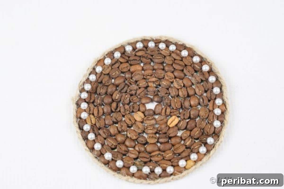 Finished coffee bean coaster resting elegantly on a pristine white surface, ready for use.