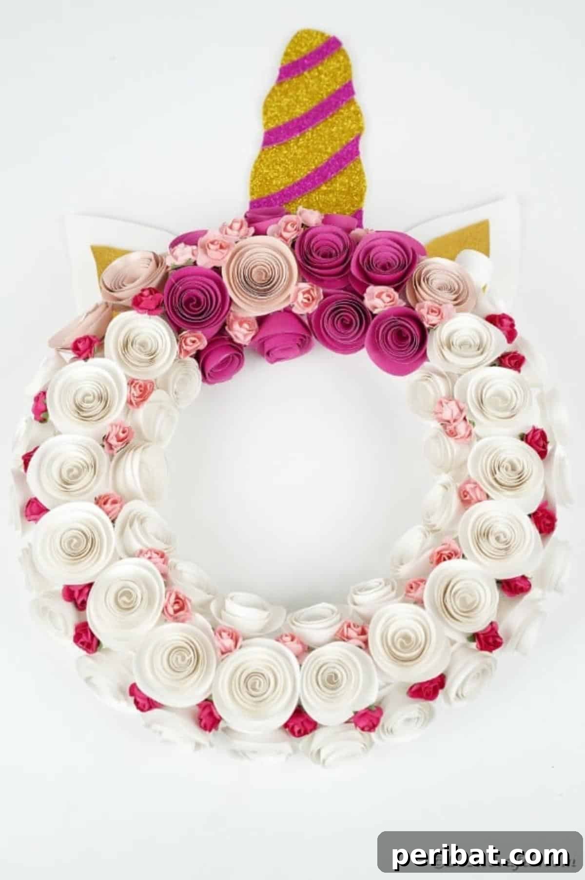 Enchanting Quilled Unicorn Wreath 19 The finished paper unicorn wreath, featuring a sparkling horn, delicate ears, and an abundance of white and pink paper flowers, hanging beautifully on a kitchen wall, ready for display.