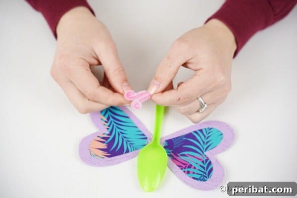 Adding pipe cleaner to top of butterfly