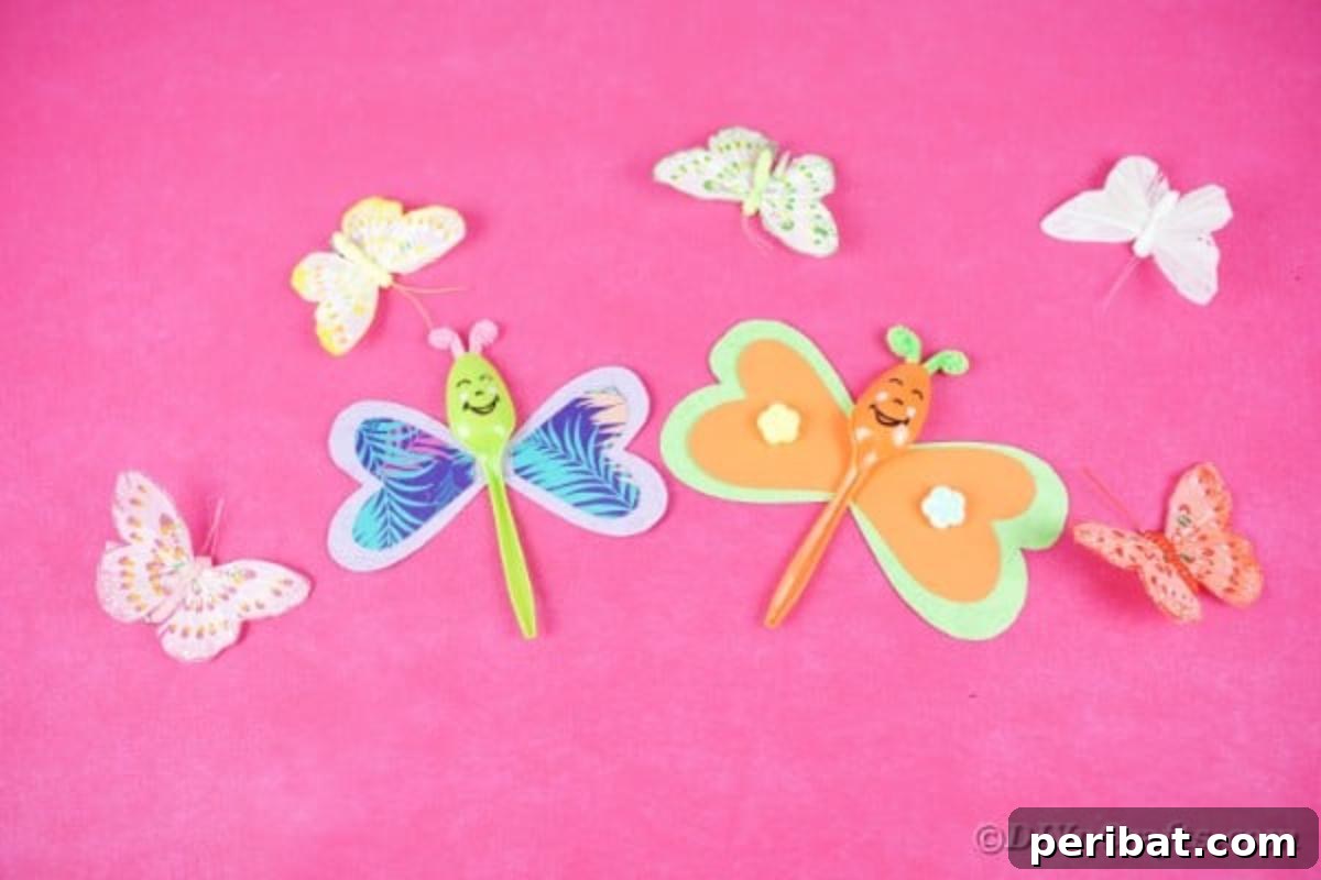Colorful upcycled spoon butterflies with detailed paper wings arranged on a vibrant pink background, highlighting their artistic appeal.