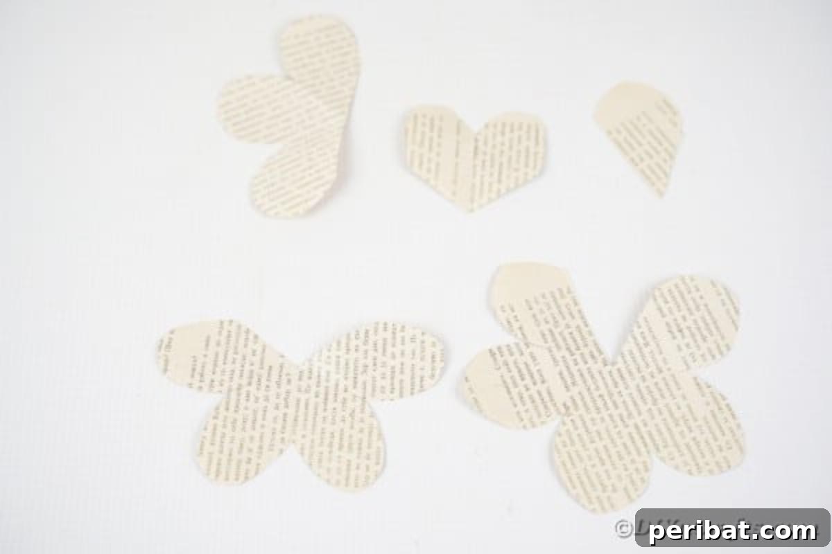 Various sized paper rose pieces arranged, demonstrating the sections cut for each flower.