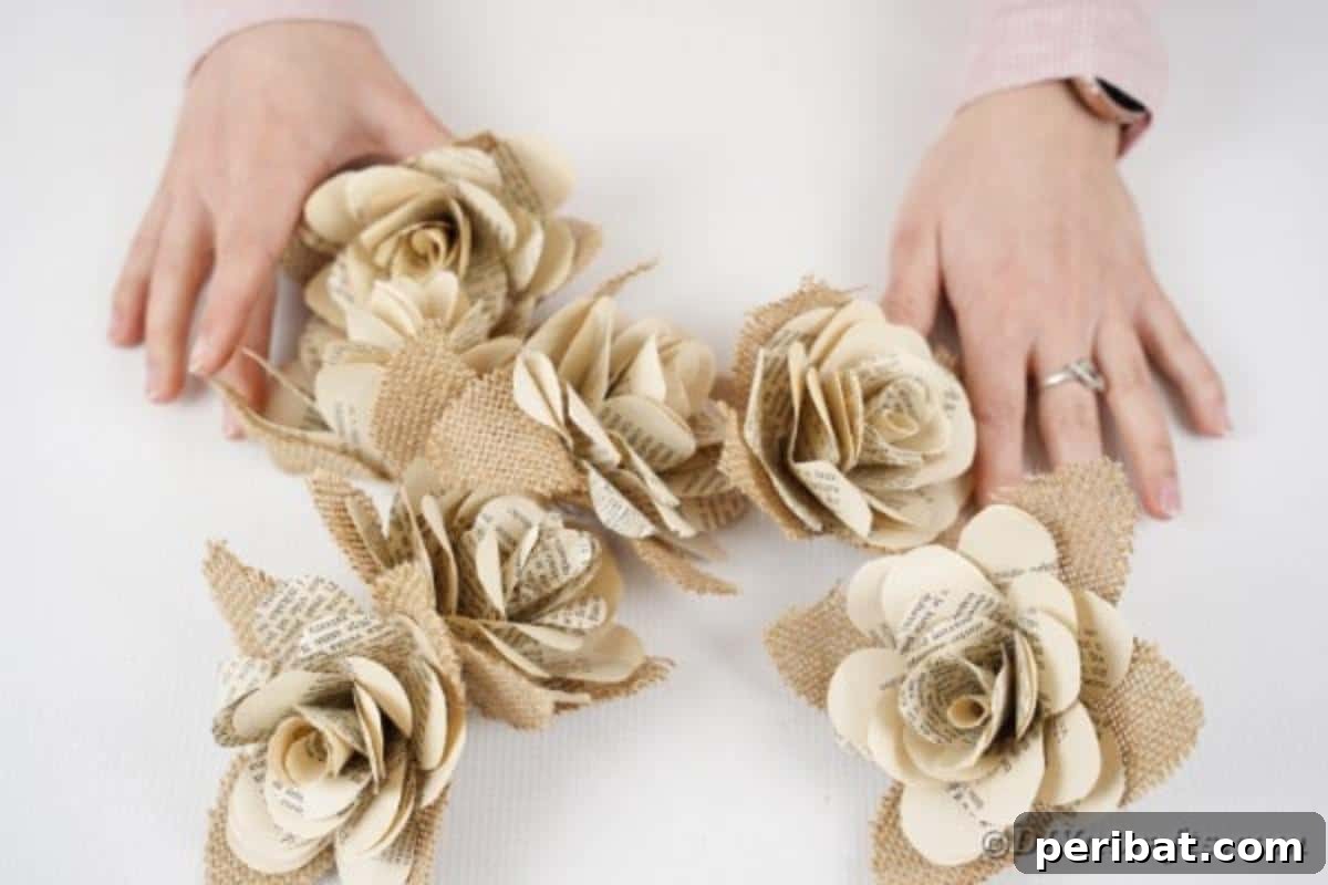 Several completed paper roses with burlap leaves, ready for placement on the wreath.