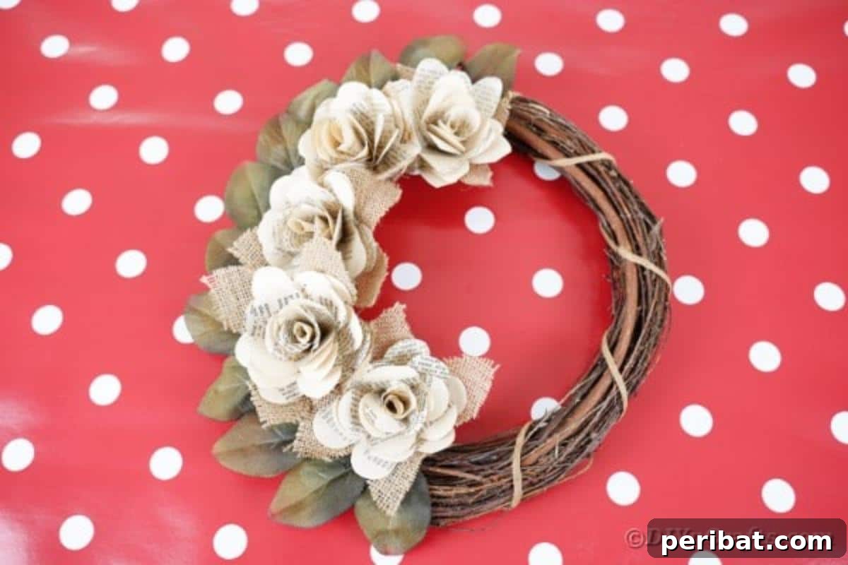 A rustic book page rose wreath displayed on a red polka dot tablecloth, emphasizing its handcrafted charm.