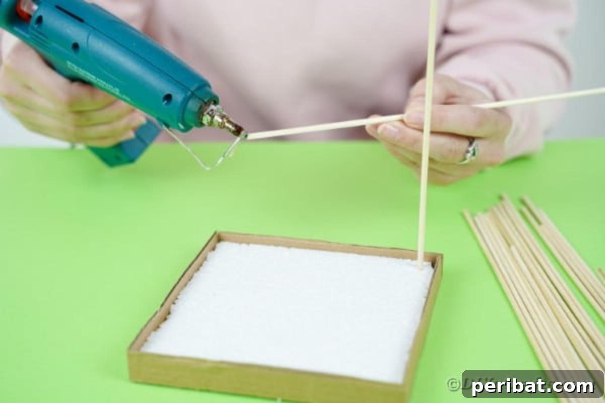 Crafting a Beautiful Floral Birdcage Display 11 Placing Skewers into Styrofoam - Inserting wooden skewers to create the birdcage bars.