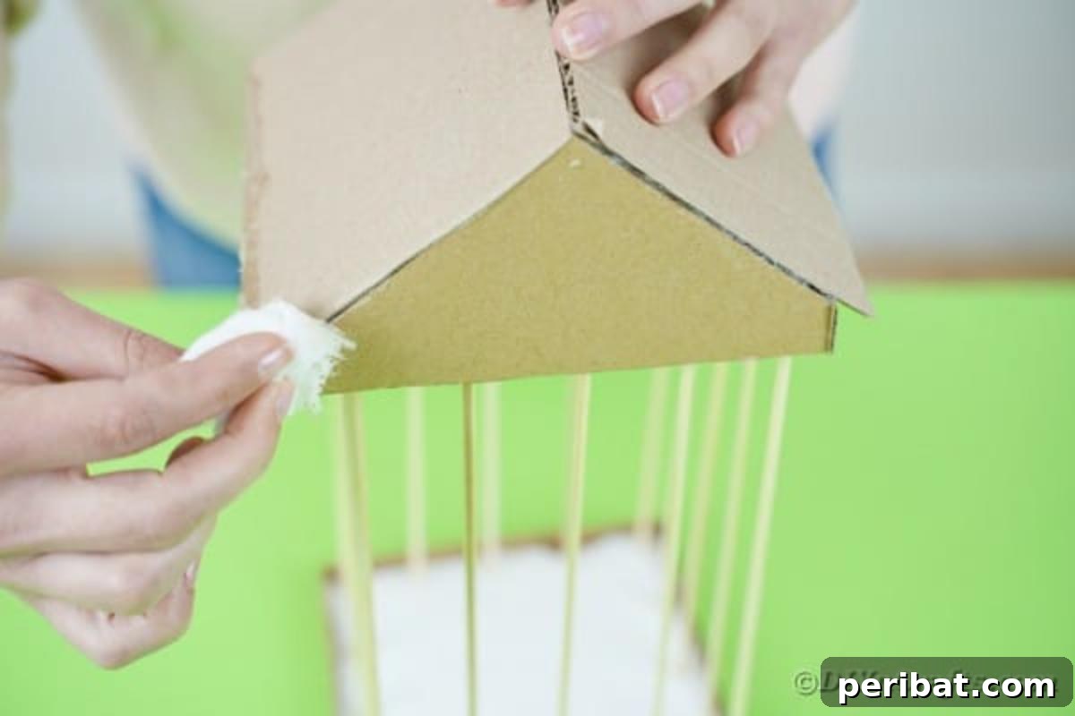 Crafting a Beautiful Floral Birdcage Display 17 Adding Petroleum Jelly to Edges of Cardboard Roof - Further application of petroleum jelly on the roof's edges.