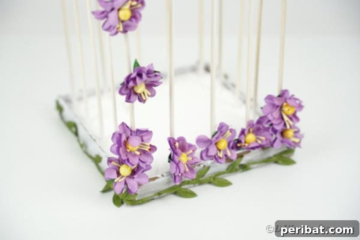 Crafting a Beautiful Floral Birdcage Display 5 Bottom of DIY Birdcage with Purple Flowers - Close-up of the base of a decorative birdcage with floral accents.