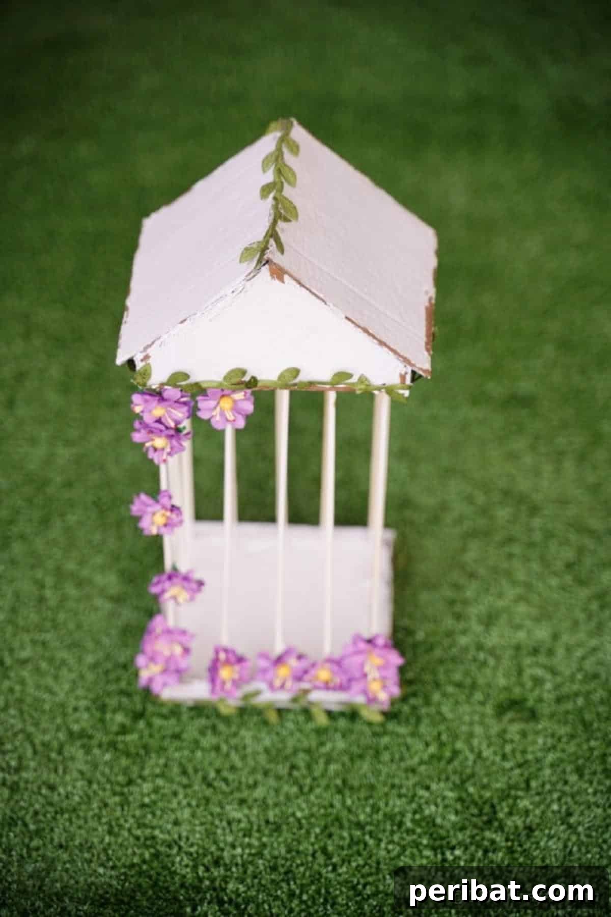 Crafting a Beautiful Floral Birdcage Display 27 Homemade Bird Cage on Grass - A charming, white DIY birdcage with floral accents, placed outdoors on lush green grass. The natural setting enhances its rustic appeal, suggesting versatility for both indoor and outdoor decorative use. Perfect for garden decor.