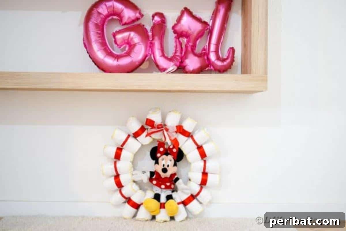 Minnie Mouse diaper wreath elegantly placed beneath a 'Girl' sign, highlighting its decorative appeal