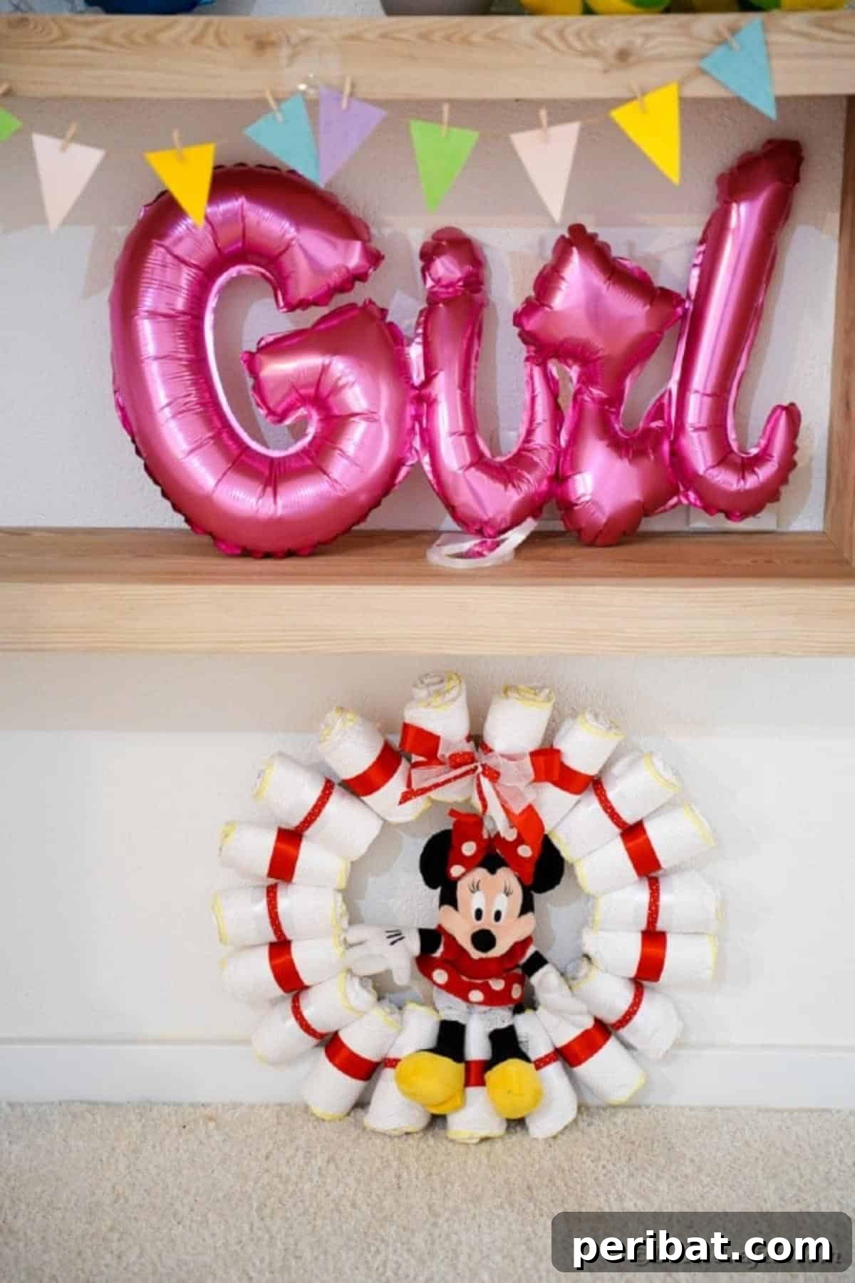 Minnie Mouse diaper wreath elegantly placed beneath a 'Girl' sign, highlighting its decorative appeal