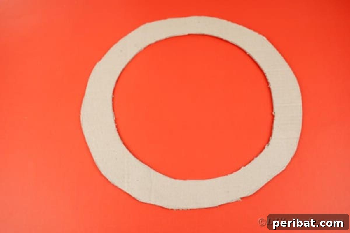 A neatly cut cardboard wreath form, ready for diaper attachment