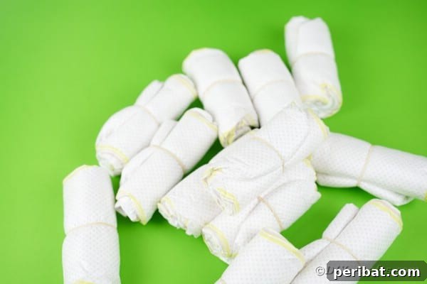 Charming Handmade Diaper Tub Shower Present 25 A stack of rolled diapers on a green table