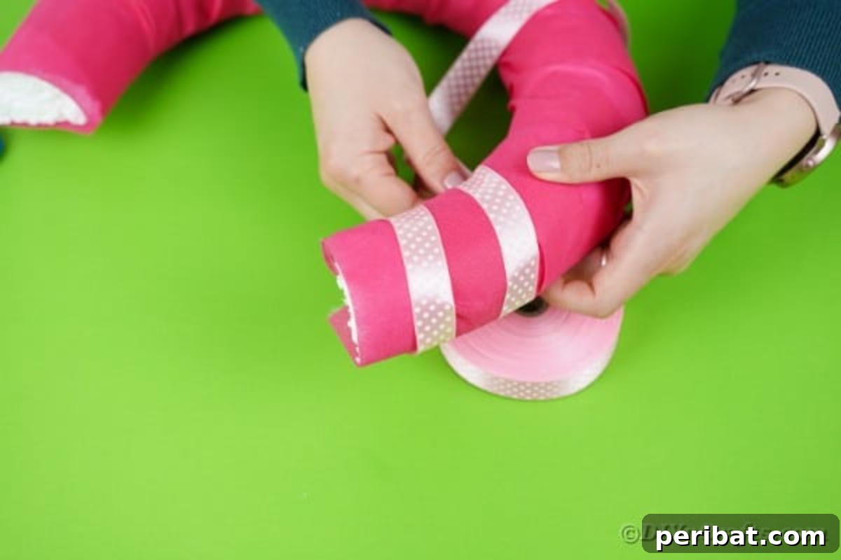 Charming Pink Handmade Diaper Basket Baby Shower Present 13 Wrapping a pink polka dot ribbon around the pink-covered basket handle, securing with glue