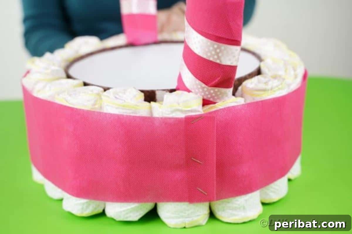 Charming Pink Handmade Diaper Basket Baby Shower Present 19 Wrapping a strip of pink tissue paper around the middle of the diaper-covered box