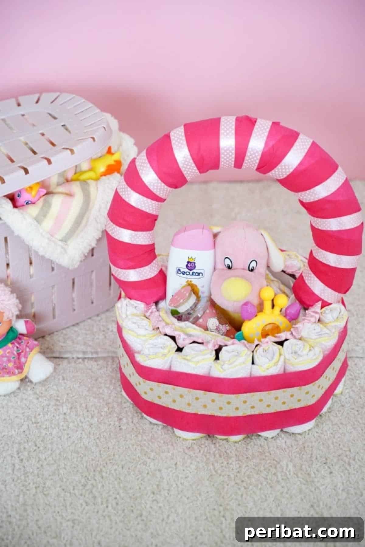 Charming Pink Handmade Diaper Basket Baby Shower Present 27 A charming diaper basket artfully arranged on a wooden table, surrounded by other baby shower decorations