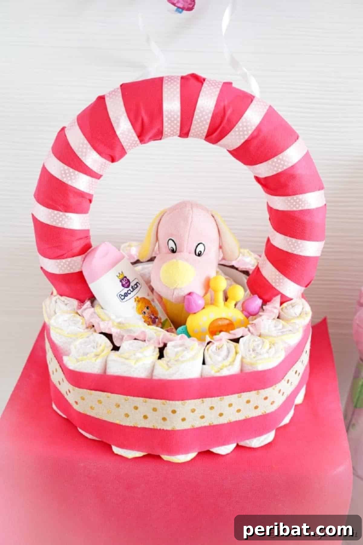 Charming Pink Handmade Diaper Basket Baby Shower Present 30 Close-up view of the diaper basket's side, showcasing the carefully rolled diapers and decorative ribbons