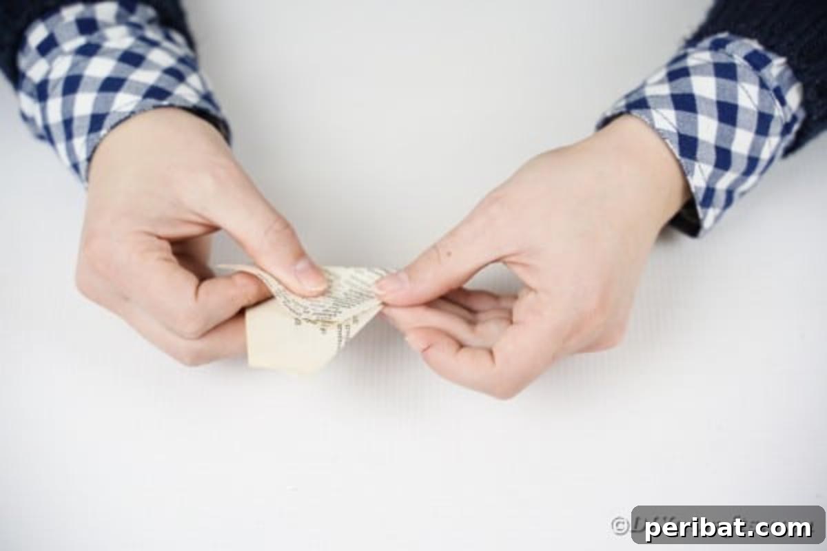 Folding book page into triangle