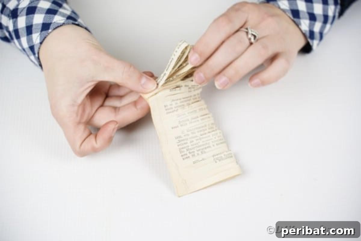 Rolling old book page into flower shape