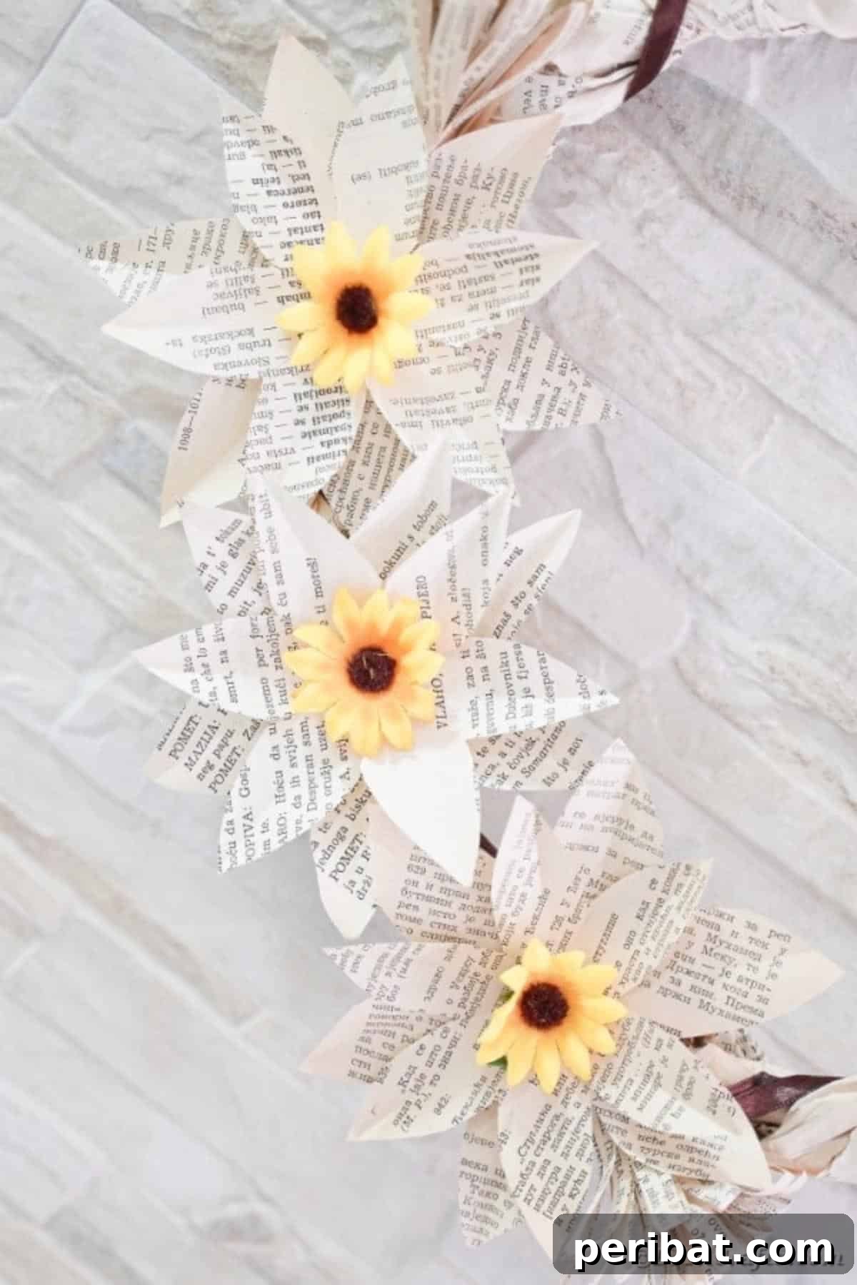 Book page sunflowers on brick wall