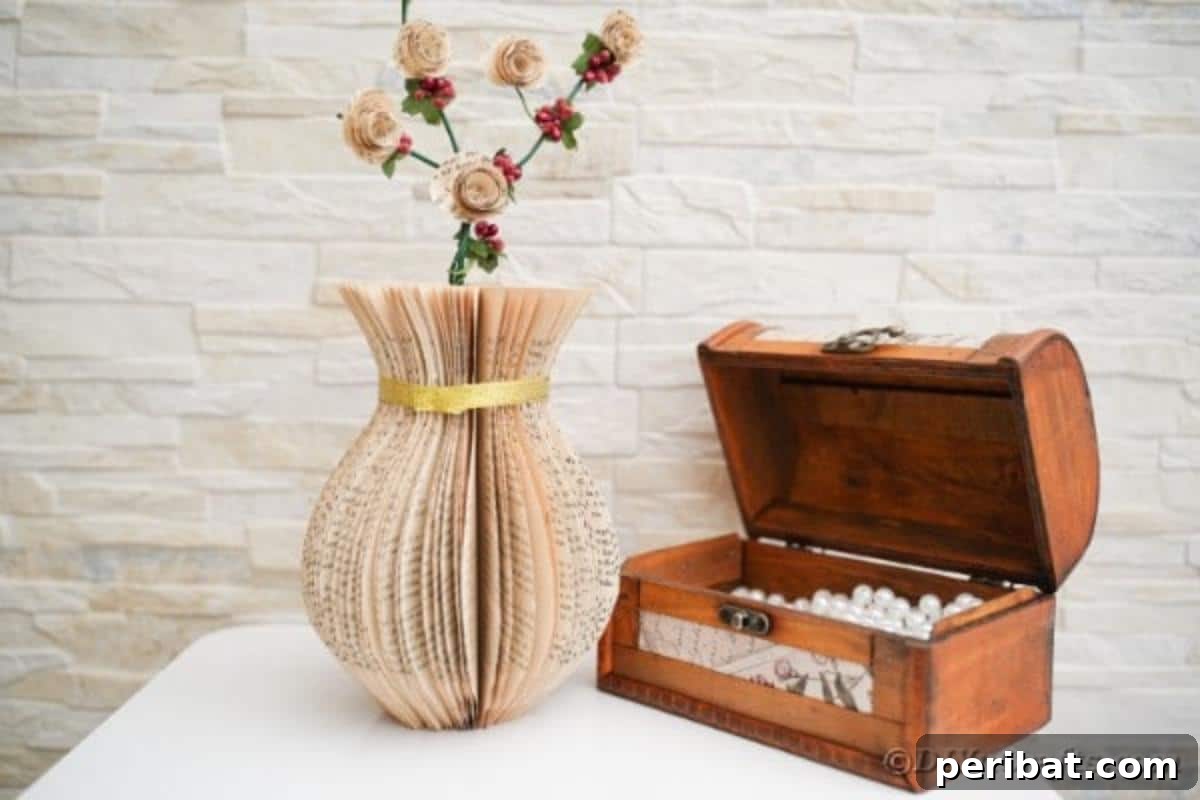 A decorative paper vase crafted from old book pages, adorned with a gold ribbon, placed on a table beside an open wooden chest, enhancing the rustic ambiance of the setting.