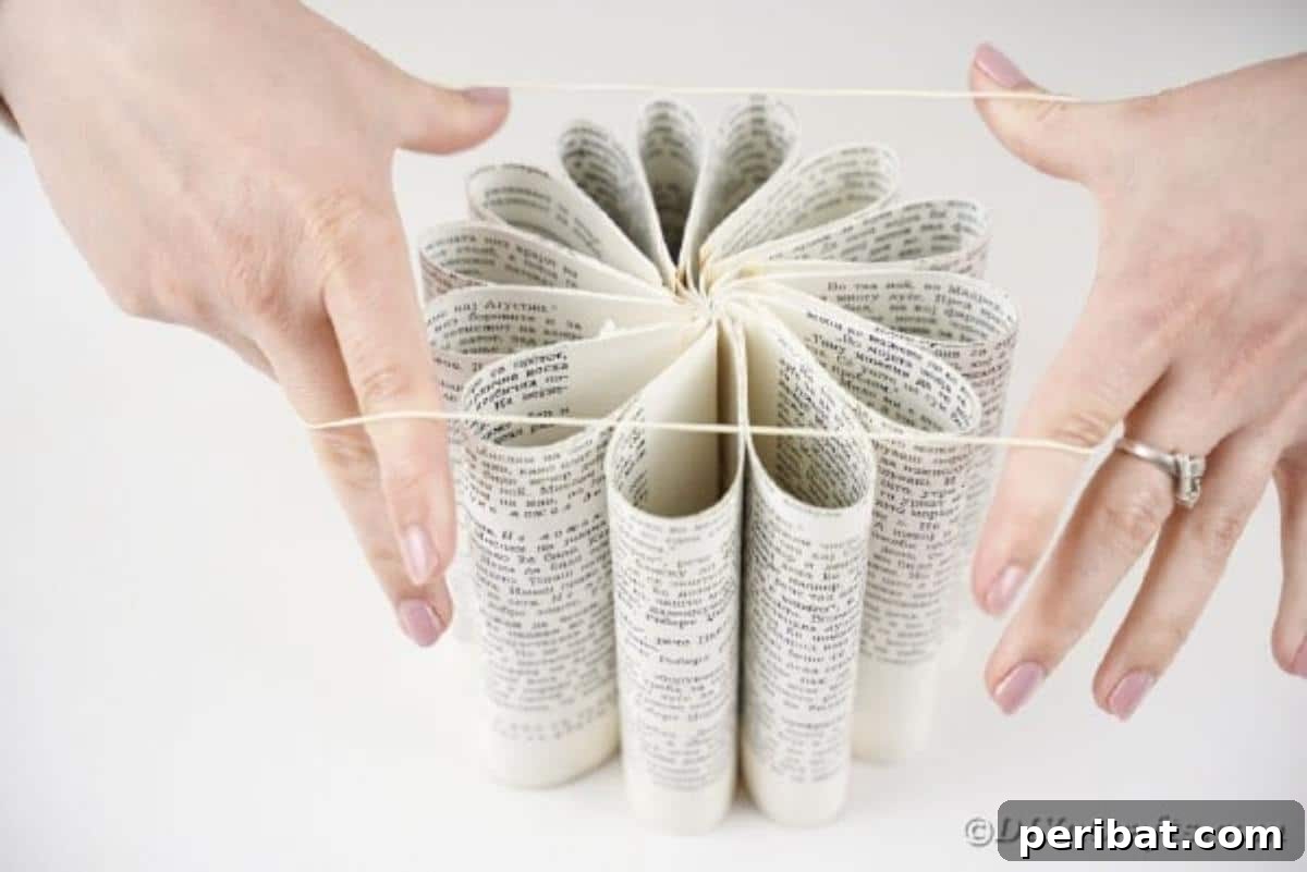 Storybook Pumpkin Charm 13 A rubber band securing the rolled book pages into a perfectly circular pumpkin shape.