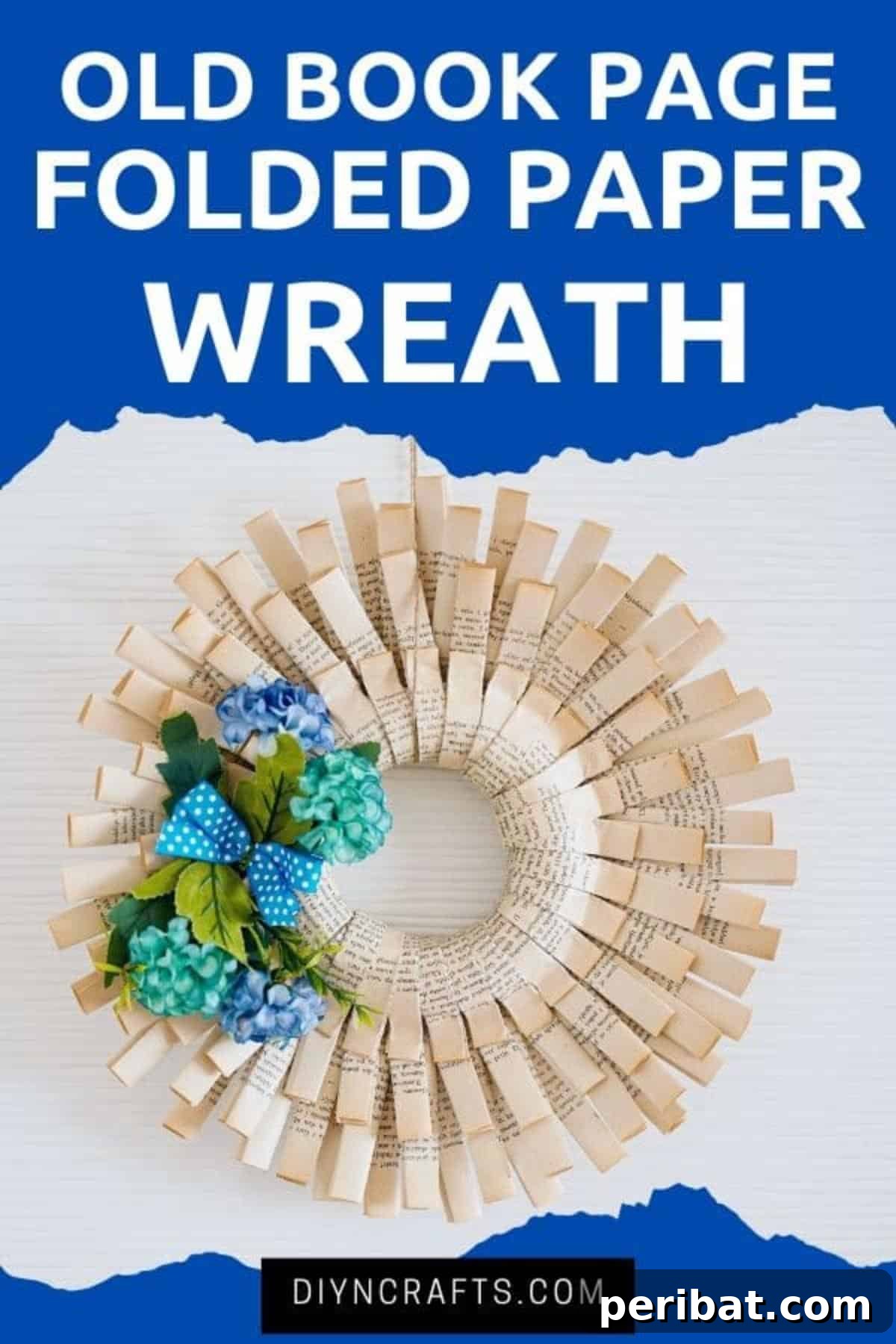 Delicate paper wreath adorned with blue flowers, hanging on a pristine white wall, showcasing intricate folds of repurposed book pages.