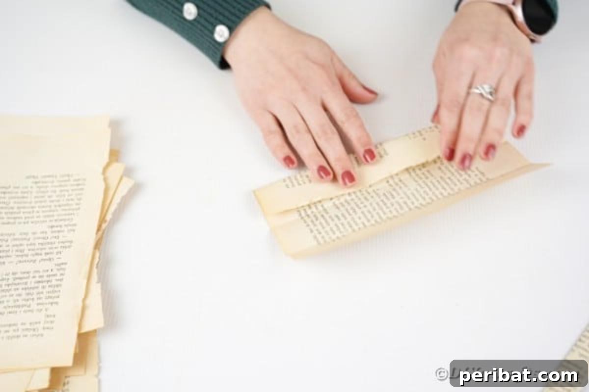 A folded paper being unfolded, revealing its creases, as it's prepared for the next folding stage.
