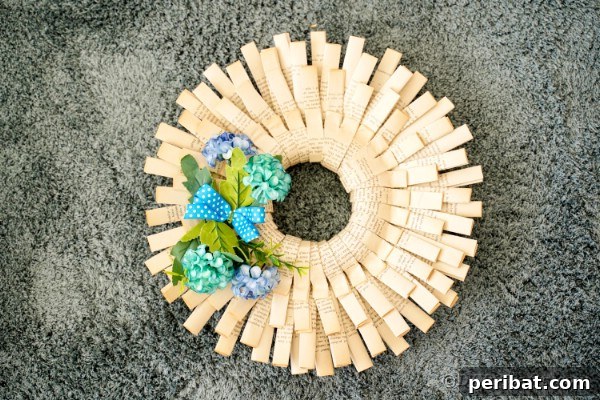 Folded book page paper wreath on carpet