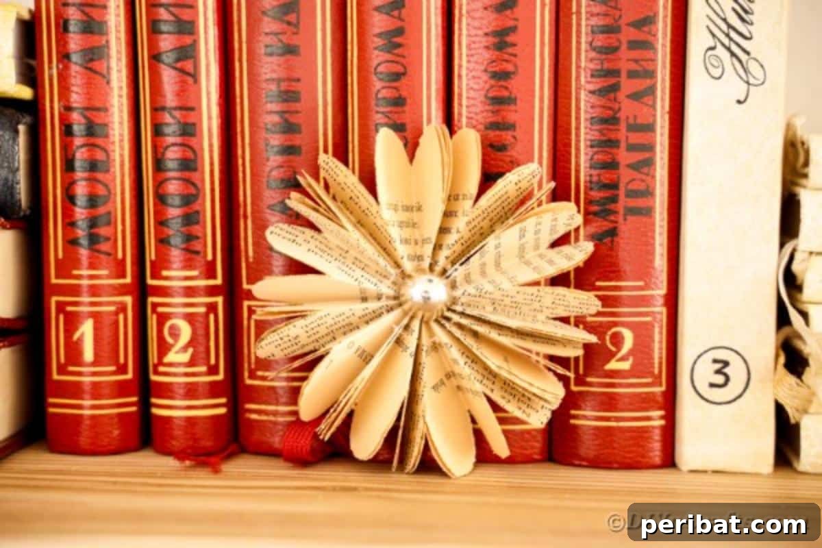Charming Blooms from Repurposed Book Pages 3 A single paper flower crafted from old book pages rests elegantly in front of a stack of vintage books
