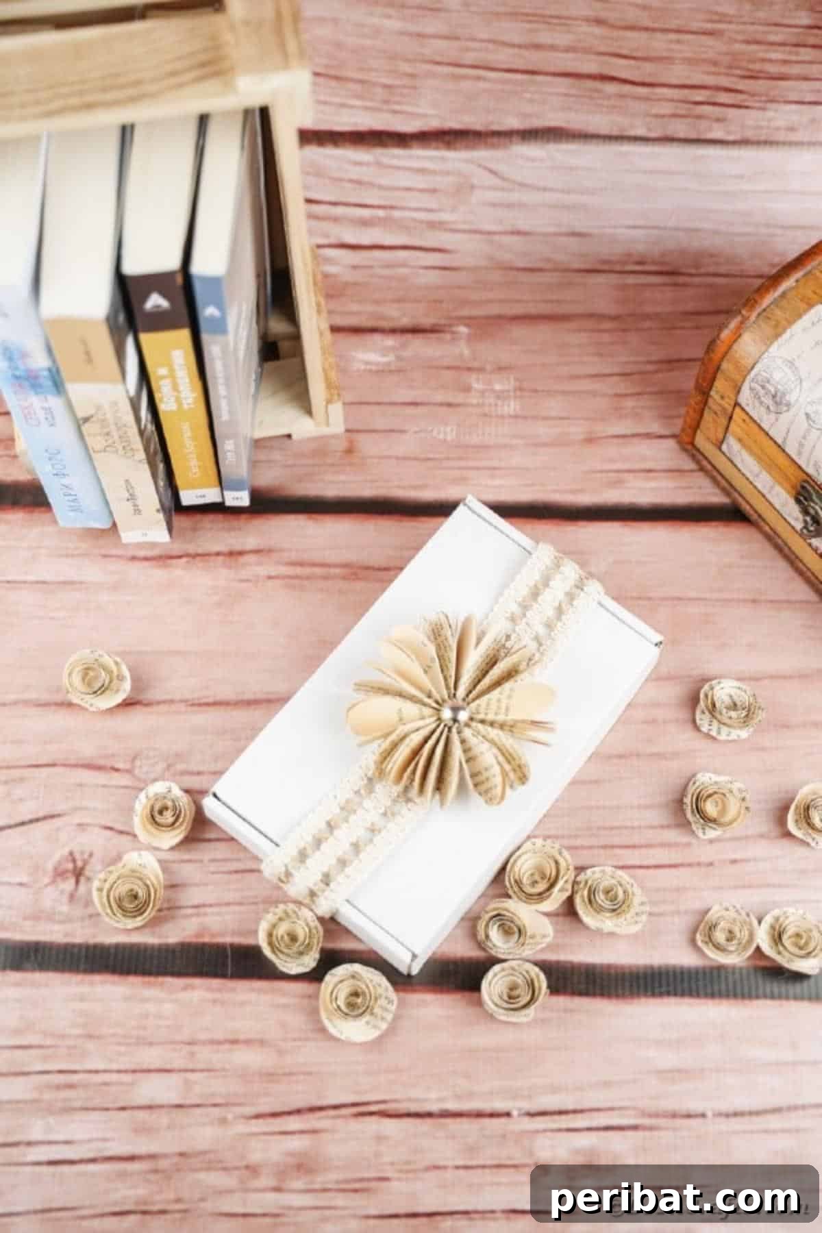 Charming Blooms from Repurposed Book Pages 21 An elegant paper flower made from old book pages rests on a crisp white box, highlighting its rustic charm