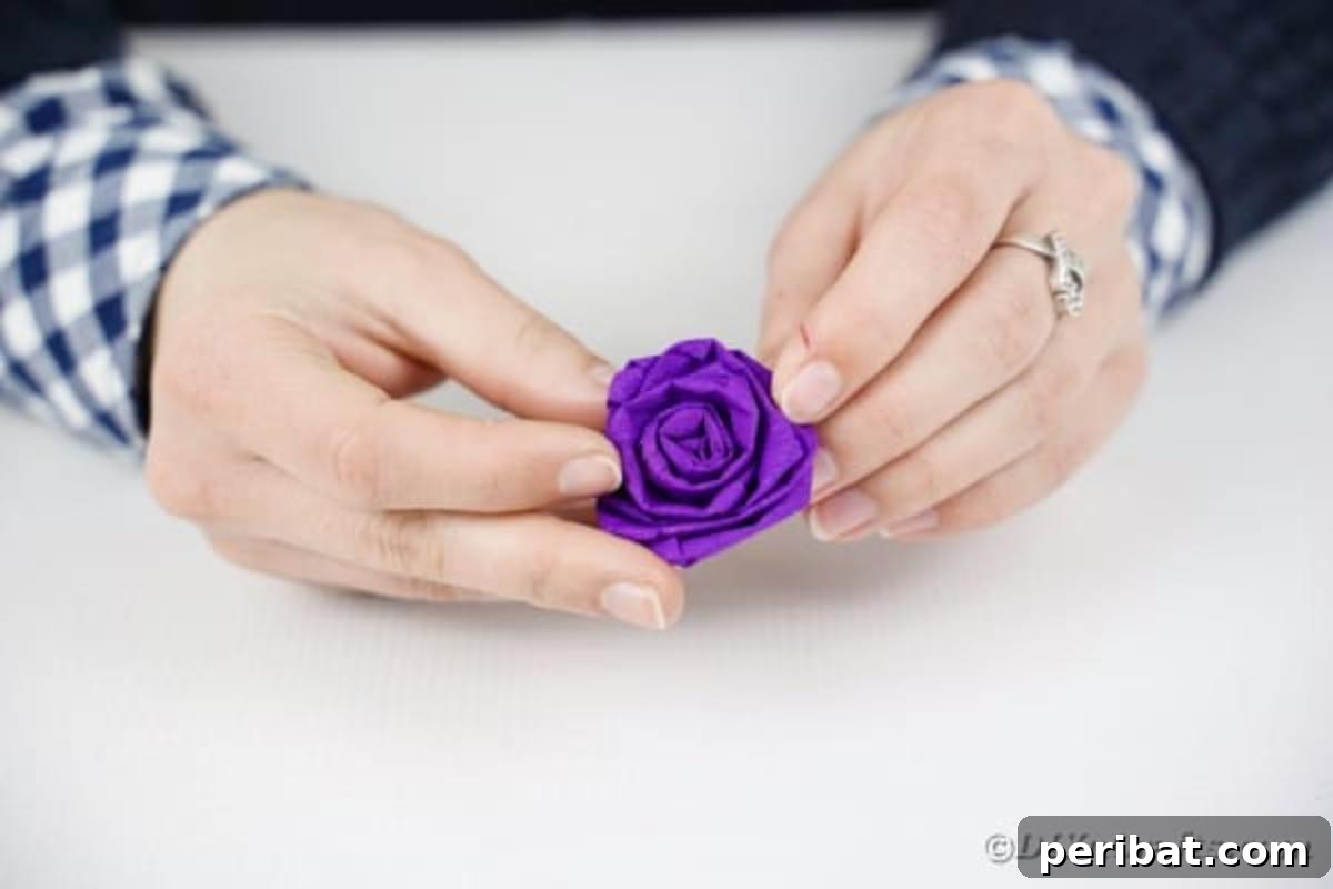 Crafting Elegant Tissue Paper Roses Step by Step 13 Rolling a purple tissue paper rose