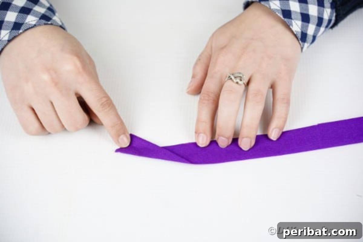 Crafting Elegant Tissue Paper Roses Step by Step 10 Rolling a purple tissue paper rose