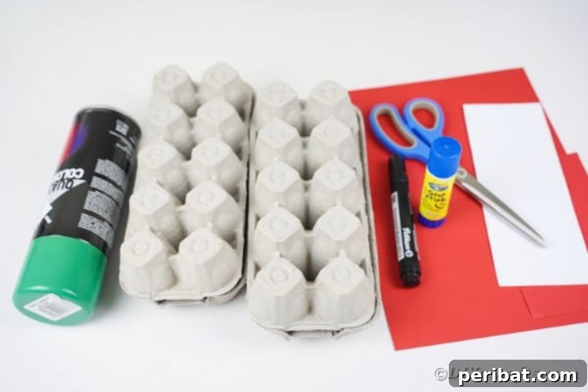 Various craft supplies laid out on a table, including egg cartons, spray paint, paper, and glue.