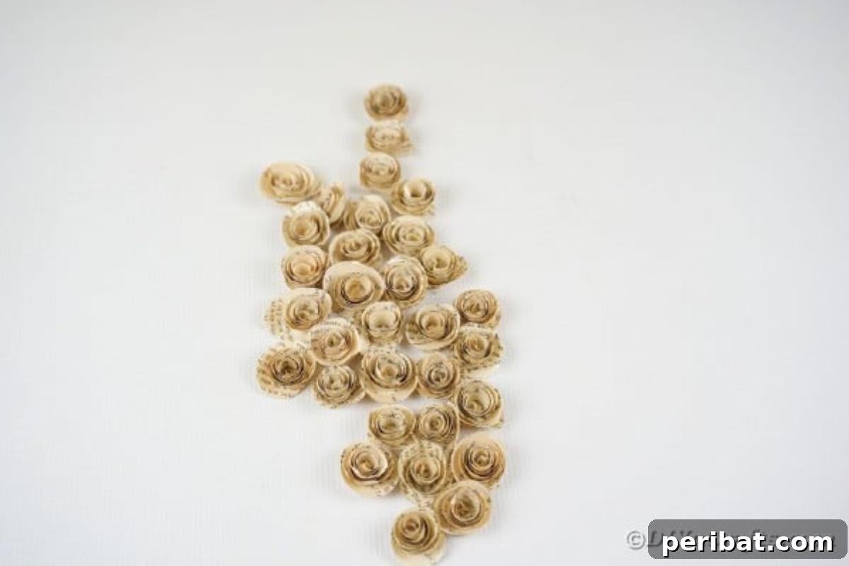 From Pages to Petals: DIY Book Rose Sphere 12 A collection of handmade paper roses made from old book pages, neatly arranged on a white table