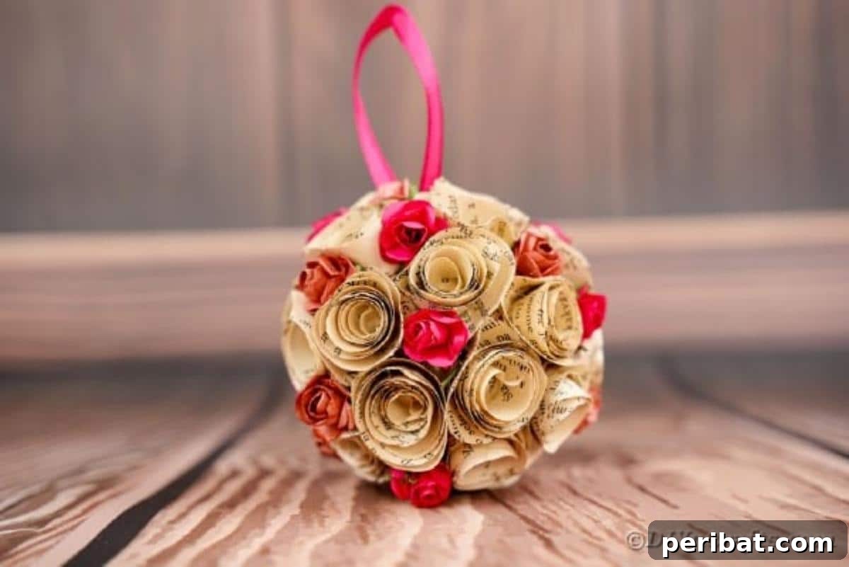 From Pages to Petals: DIY Book Rose Sphere 3 A beautifully crafted paper rose ball rests on a wooden table, showcasing its delicate textures