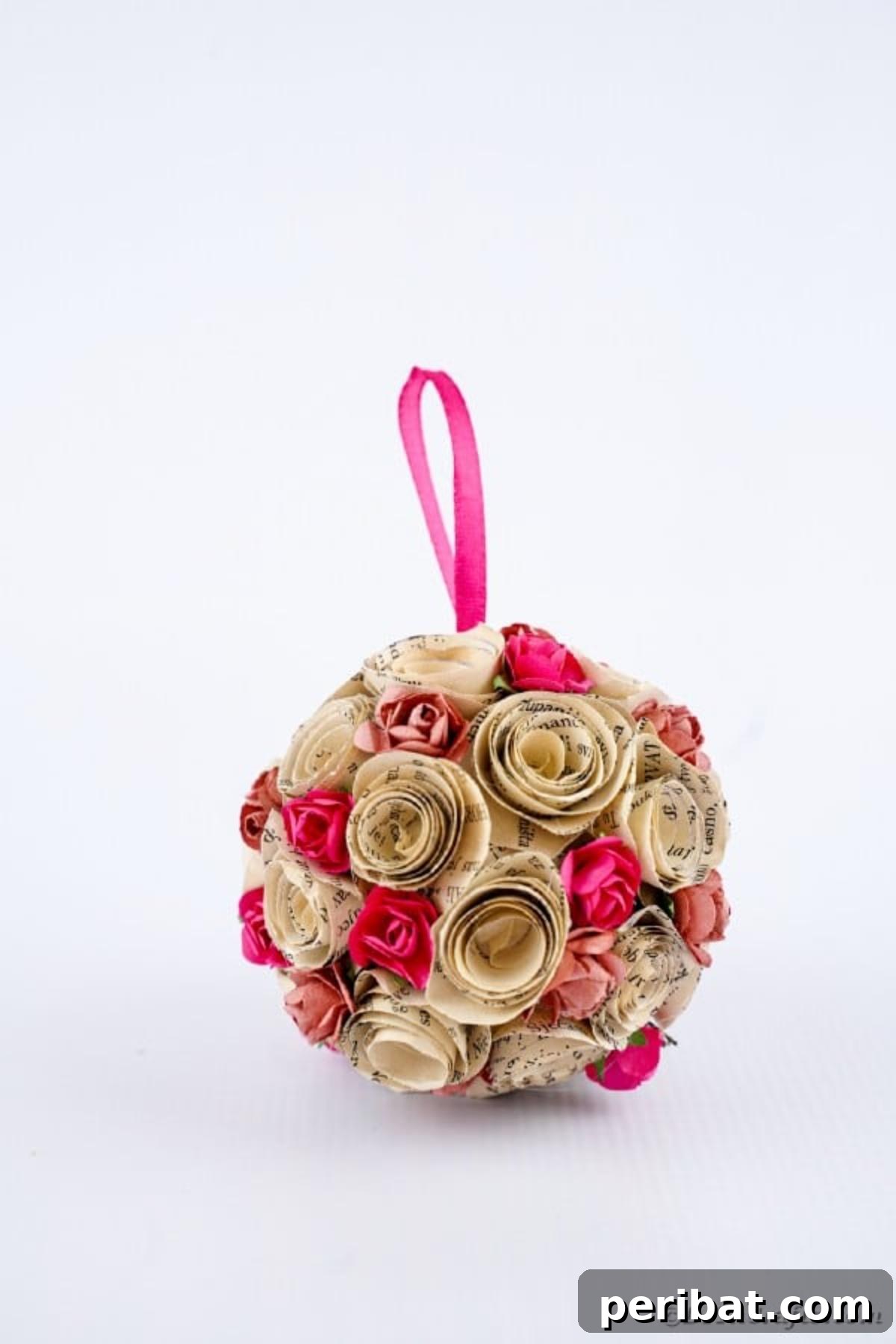 From Pages to Petals: DIY Book Rose Sphere 22 The stunning paper rose ball showcased on a clean white counter, highlighting its intricate design