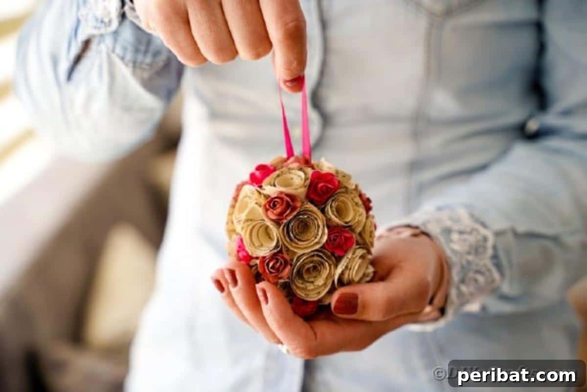 From Pages to Petals: DIY Book Rose Sphere 5 A close-up shot of a crafter holding a newly made paper rose ball, highlighting the intricate details