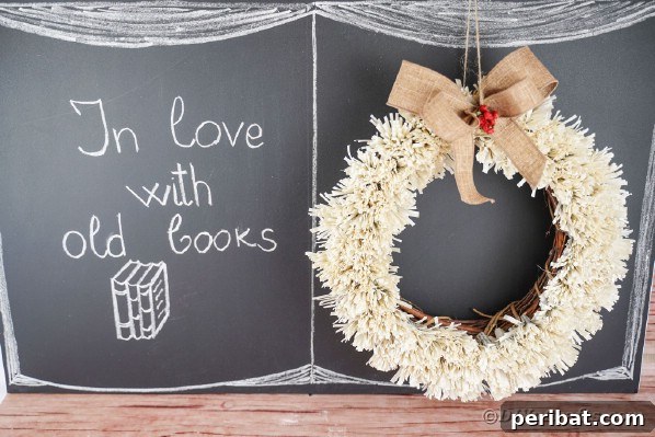 Fringed wreath hanging elegantly on a rustic chalkboard backdrop
