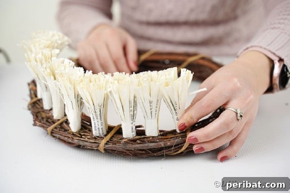 Gluing frigned paper flowers to grapevine wreath