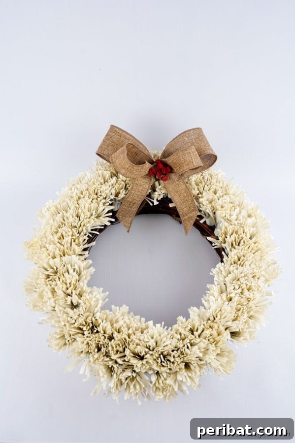 Fringed wreath against a plain white background, emphasizing texture