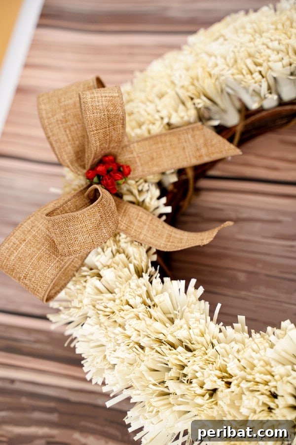Paper fringed wreath displayed on a warm wooden surface