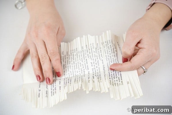 Opening up a book page after fringing, revealing the central solid strip