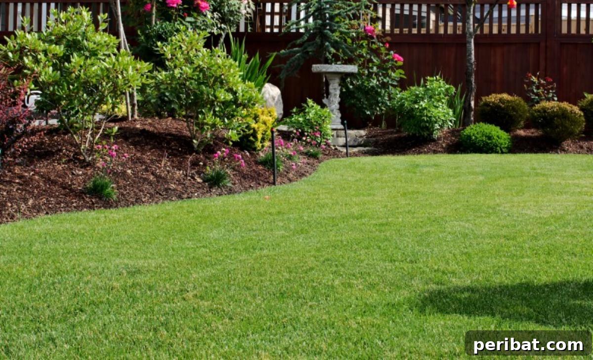 Beautiful mulched garden bed next to perfect lawn.