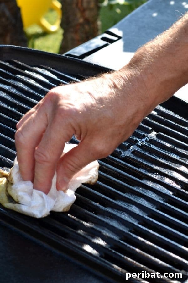 Essential Summer Hacks for a Stress-Free Season 8 Man cleaning a grill