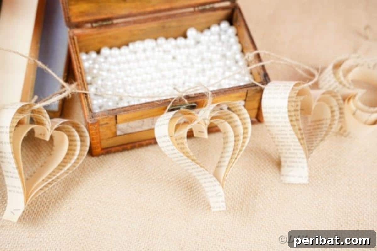Heirloom Book Page Heart Bunting 3 Rustic paper heart banner draped over an open wooden chest