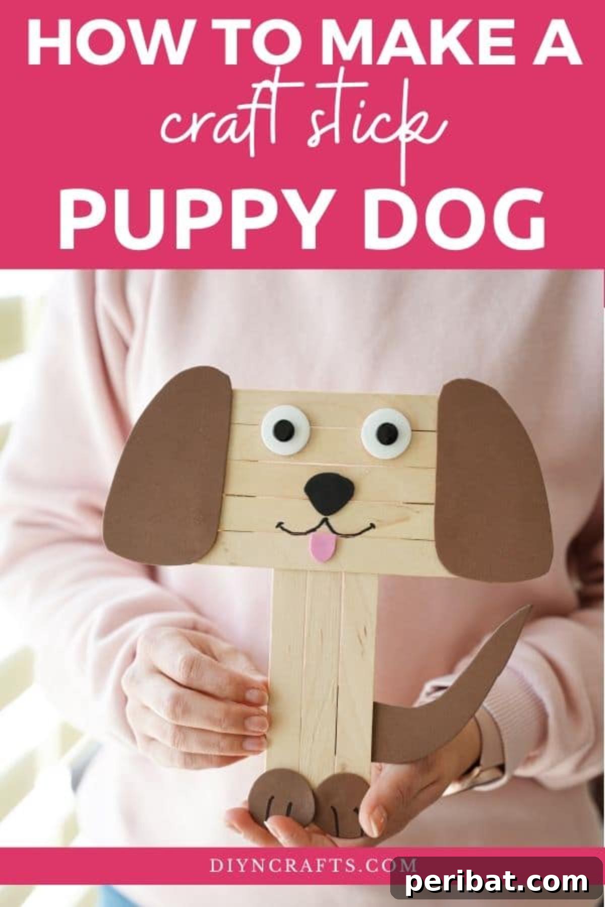 Woman holding a finished craft stick dog puppet
