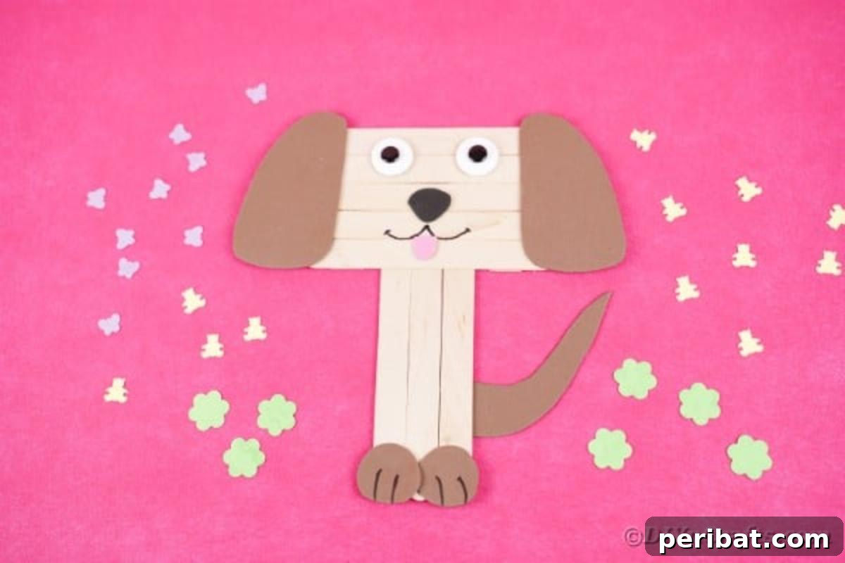 Cheerful popsicle stick puppy on a vibrant pink surface