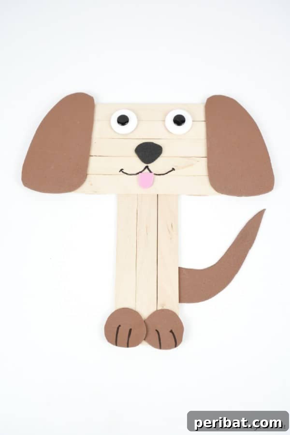 Simple yet charming craft stick puppy on a clean white surface