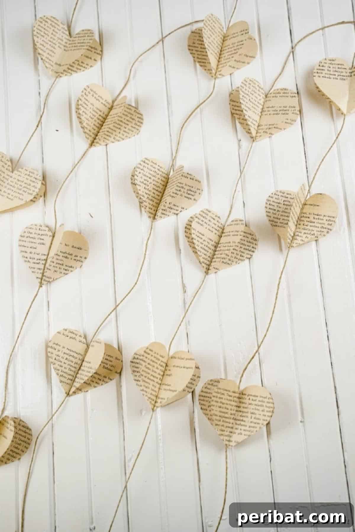 Close-up of the delicate paper heart garland against a crisp white background, emphasizing its handcrafted detail