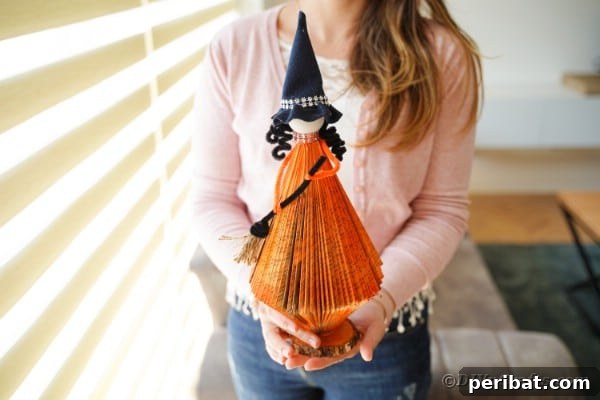 Upcycled Book Floating Witch Halloween Decor 3 Woman holding paper witch