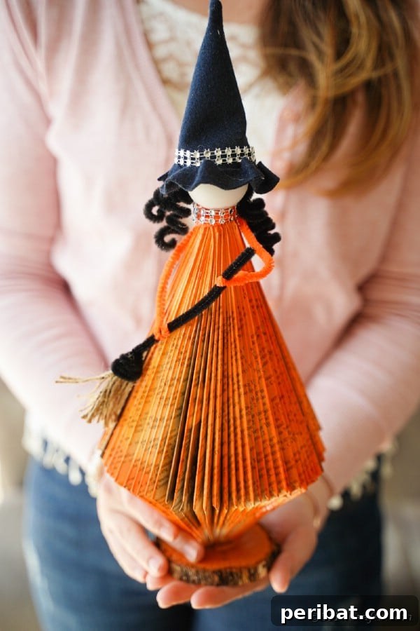 Upcycled Book Floating Witch Halloween Decor 23 Witch in front of wood paneling